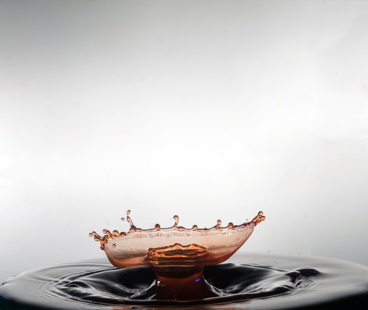 Photo close-up of liquid splashing against white background