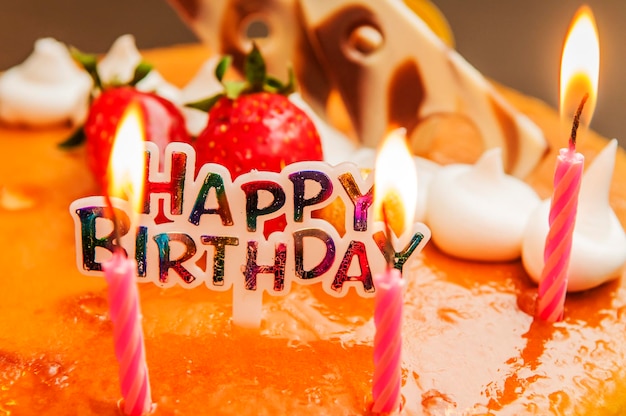 Photo close-up of lit candles on birthday cake