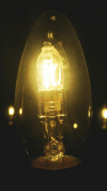 Photo close-up of lit lantern over black background