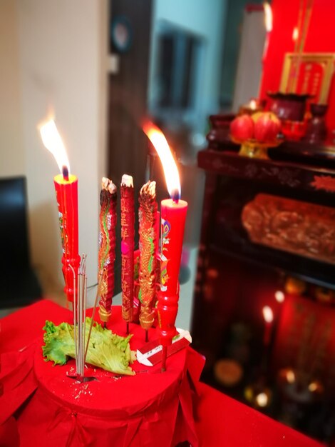 Close-up of lit tea light candles at home
