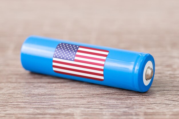 Close up of lithium battery with flag of USA on table