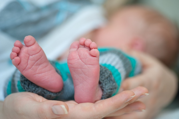 Close up of Little baby feet with mother hand