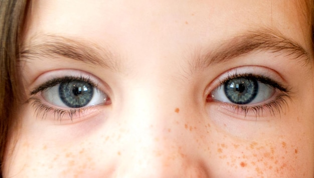 Close up of the little girl eyes opening and closing portrait shot high quality photo