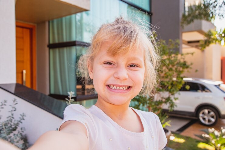 Close up little girl taking a selfie.