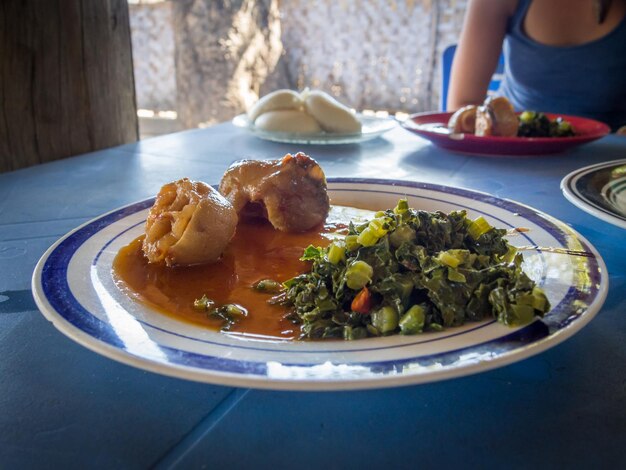 Photo close-up of local food in plate on table zambia