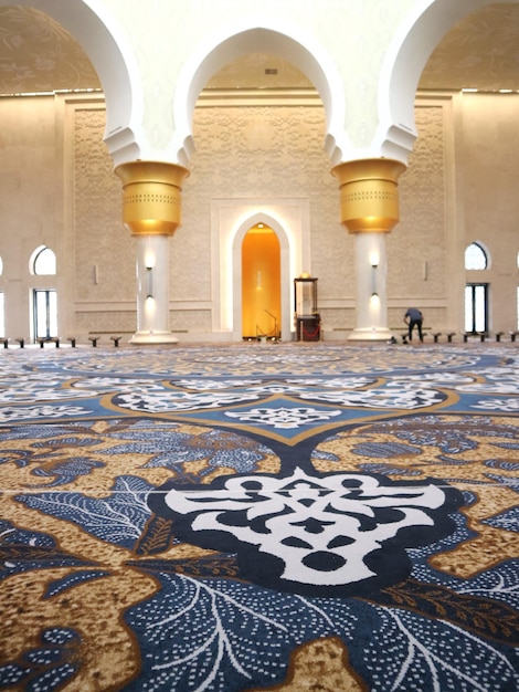 Close up look of batik pattern on carpet with pillar on background of Zayed mosque Solo Indonesia