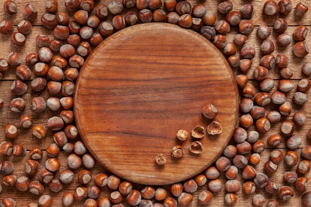 Close-up of a lot of hazelnuts on vintage wooden background. 