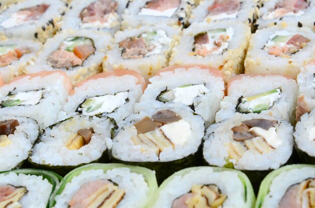 Close-up of a lot of sushi rolls with different fillings