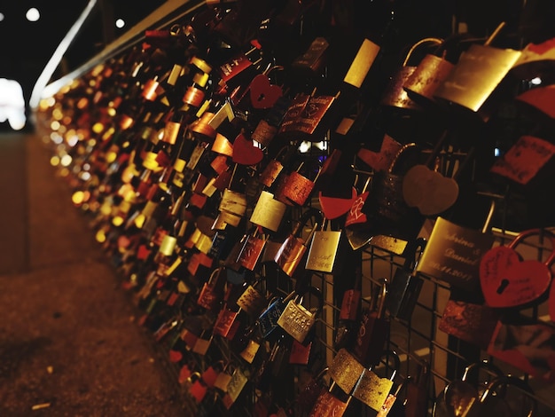 Photo close-up of love locks hanging at night