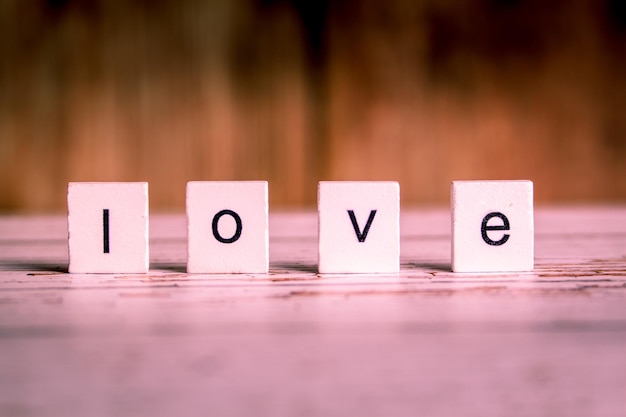 Photo close-up of love text with blocks on table