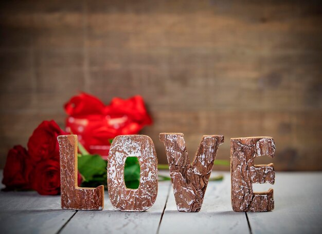 Photo close-up of love text with flower on table