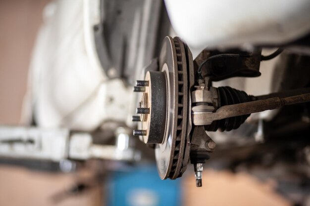 A close up of a machine with a nut and a nut on it Disc brake of the vehicle for repair