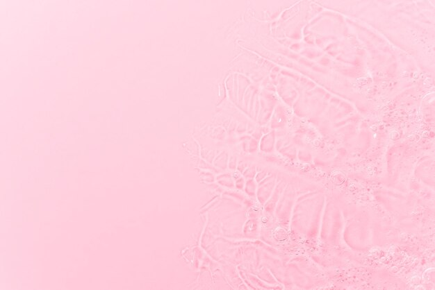 Close up macro Aloe vera gel cosmetic texture pink background with bubbles