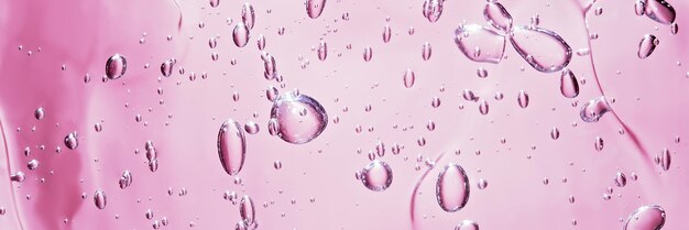 Close up macro aloe vera gel cosmetic texture pink background with bubbles