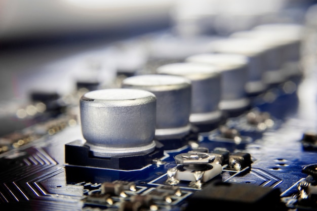 Close up macro of aluminum electrolytic capacitors installed on the motherboard.