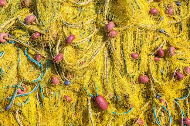 Close up macro image of old yellow fishing net