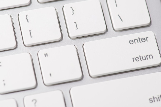 Close up macro photo of computer keyboard and white button enter