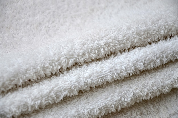 Close-up macro photo of a stack of many small white towels