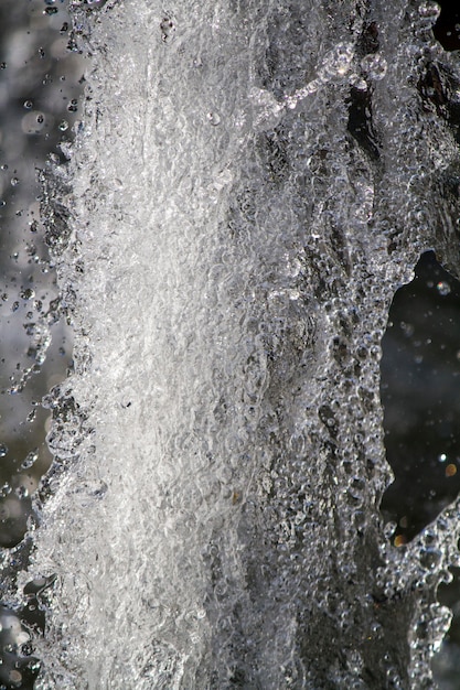 Close up macro view of a burst of many tiny water droplets.