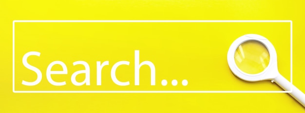 Close-Up Of Magnifying Glass On Yellow Background witn text Search. WEB SEARCH CONCEPT.