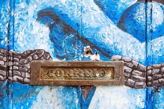 Photo close-up of mailbox on old door