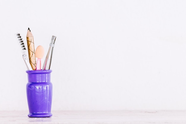 Photo close-up of make-up tools on table against white background