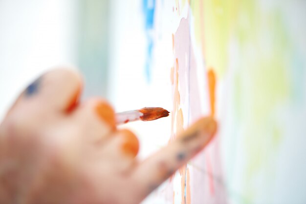 Close up of male artist hand, drawing picture at workshop