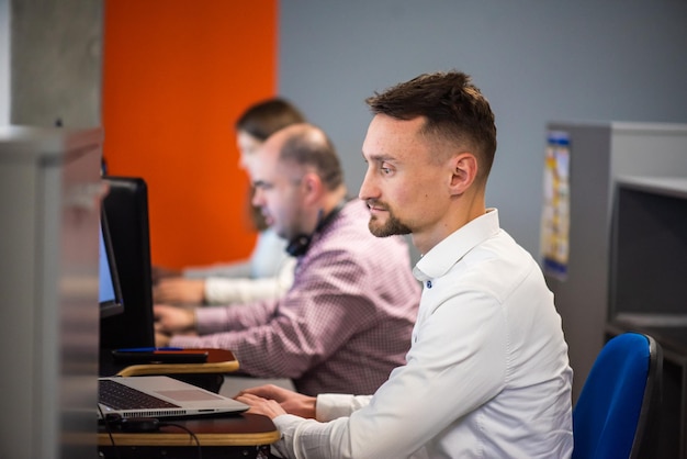 Close up of male colleagues cooperating in coworking office space