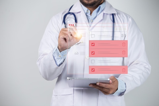 Close up of male doctor checking email with virtual reality on white background