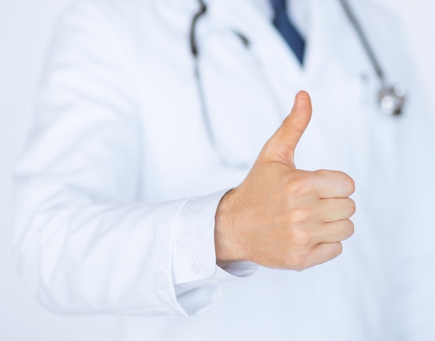 close up of male doctor hand showing thumbs up