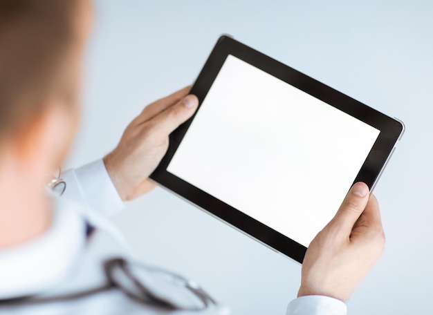 close up of male doctor hands holding tablet pc