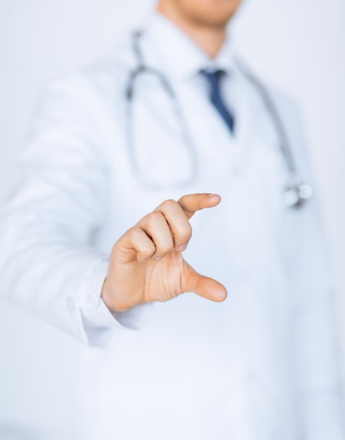 close up of male doctor holding something in his hand