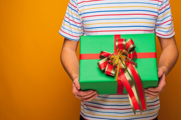 Close up male hands holding present gift box