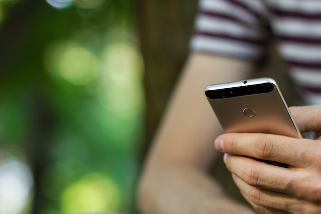 Close up male hands holding smartphone cell telephone