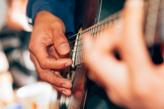 Close-up on male hands playing a classical guitar