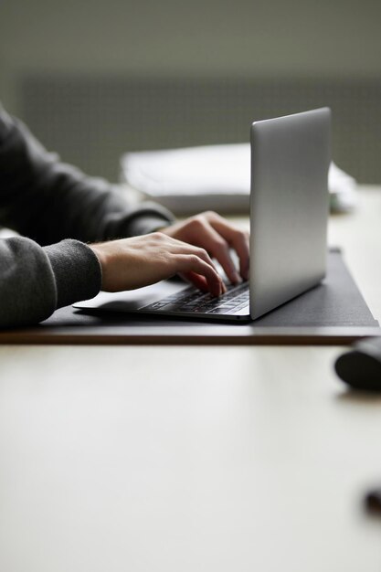 close-up male hands typing on a laptop keyboard. office work. working on a laptop