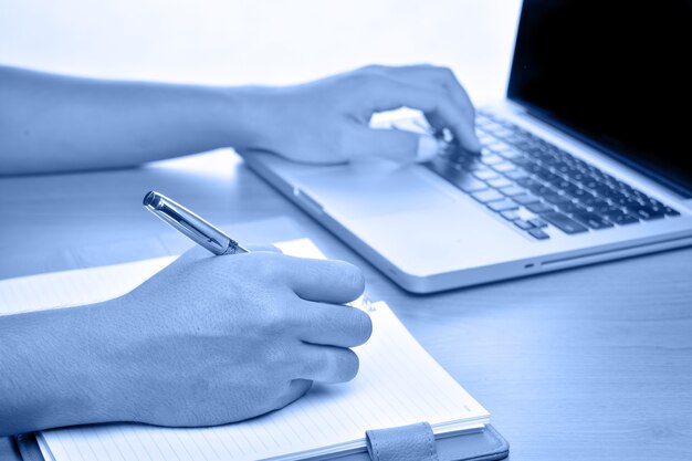 Close up of male hands using Laptop on the desk