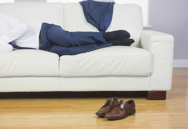 Close up of male legs lying on couch