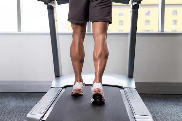 Close Up Of Male Legs Running On Treadmill Blurred Motion