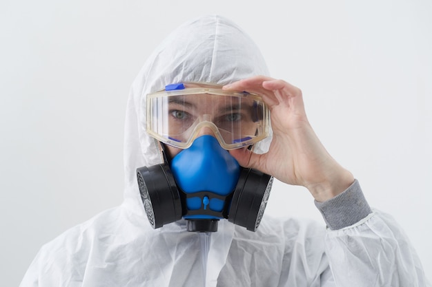 Close-up. male sanitizer wearing a protective suit and an antiviral mask.