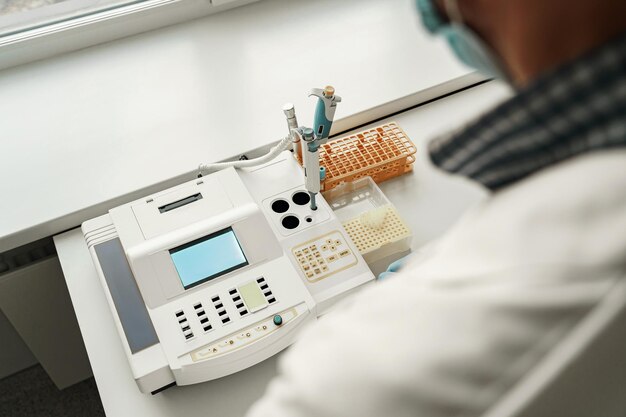 close up of male scientist in uniform working in medical research laboratory use special equipment