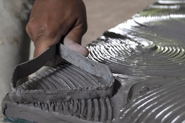 Close up of male sculptor holding tool and making art on clay Clay master moulding Clay modelling