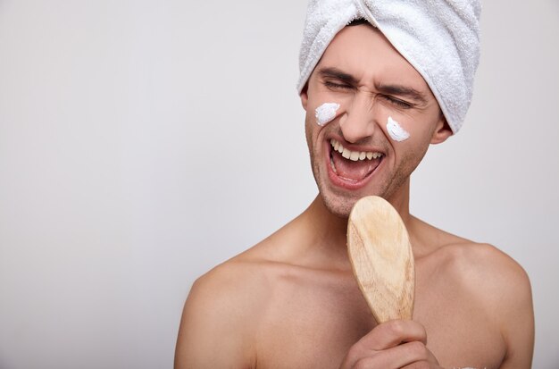 A close-up of a man after a shower and a spa sings.