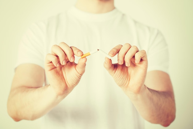 close up of man breaking the cigarette with hands