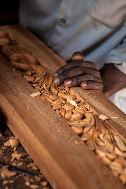 close-up of man carving wood
