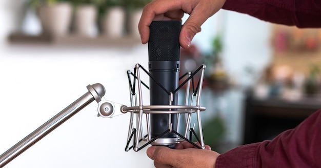 Close up of a Man Checking Microphone For His Podcast