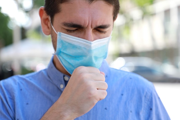 Close-up of man coughing in city