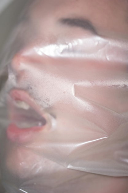 Close-up of man covered in plastic