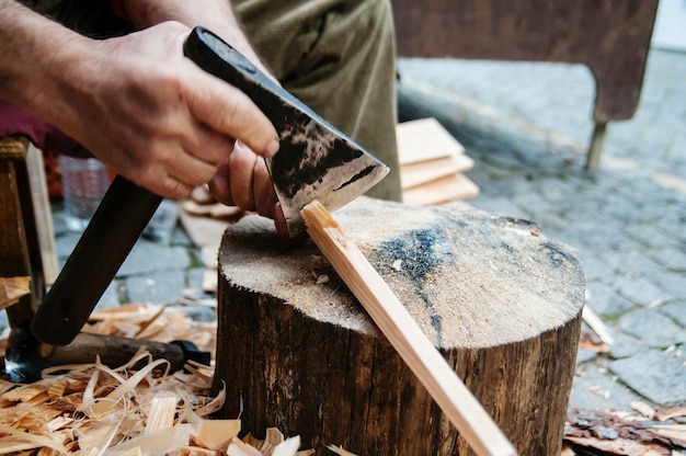 close-up of man cutting wood