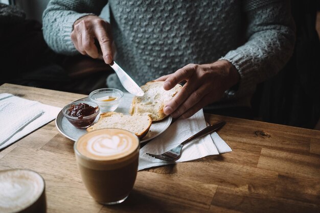 Close-up of man eating breakfast in cafe